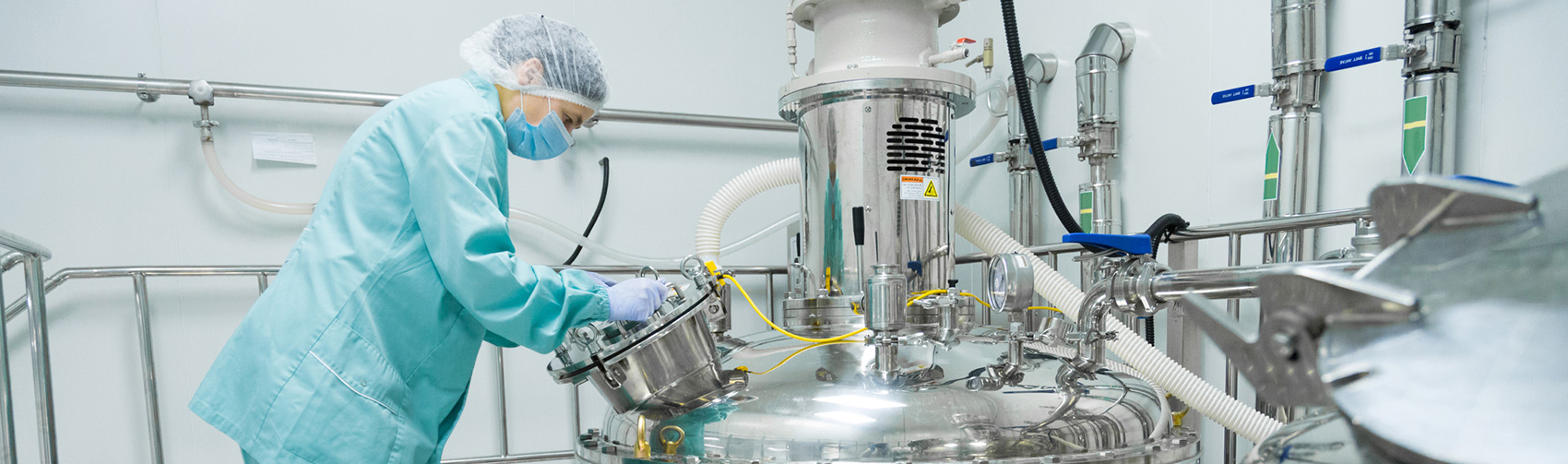 technician manufacturing tablets in industrial lab